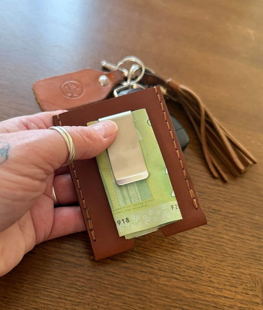 handmade leather wallet holding cards and cash